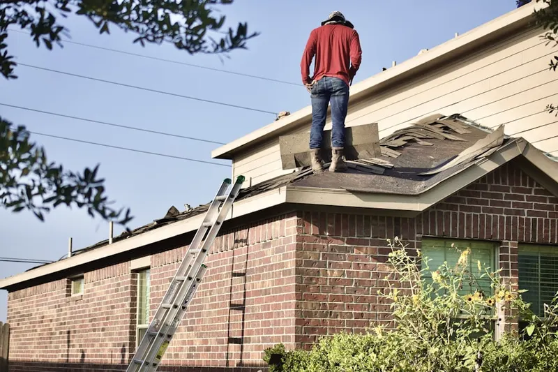 Professional roofer working on a residential roof in Ridgefield